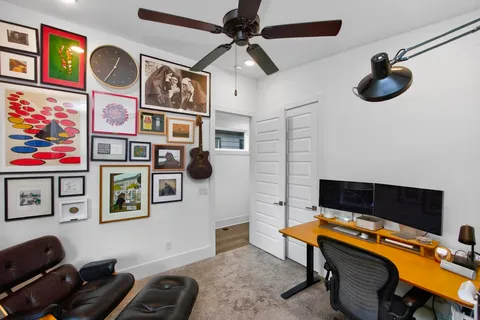 a workspace with furniture and ceiling fan