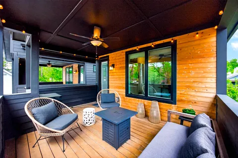 a outdoor living space with furniture potted plant and a large window