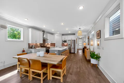 a view of a dining room with furniture window and wooden floor