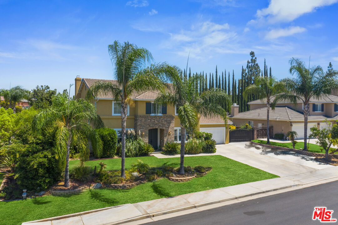 8256 Daisy Lane Riverside, CA 92508 - Photo 1 of 29 a front view of a house with garden and trees