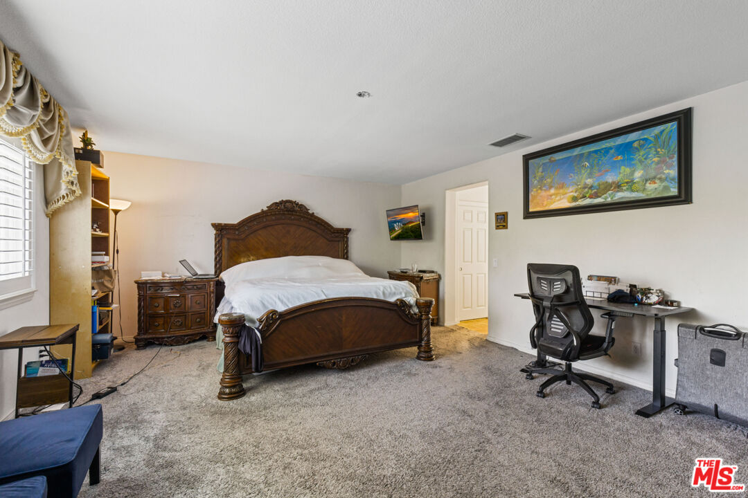 8256 Daisy Lane Riverside, CA 92508 - Photo 14 of 29 a bedroom with a bed a desk and chair