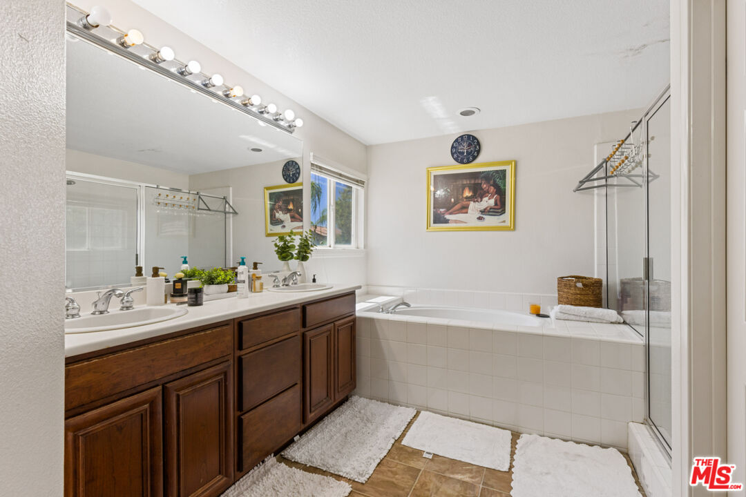 8256 Daisy Lane Riverside, CA 92508 - Photo 15 of 29 a bathroom with a tub sink and mirror