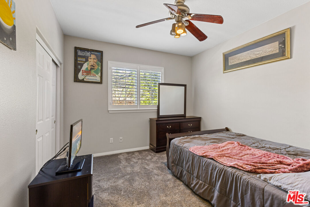 8256 Daisy Lane Riverside, CA 92508 - Photo 19 of 29 a bedroom with a bed and wooden floor