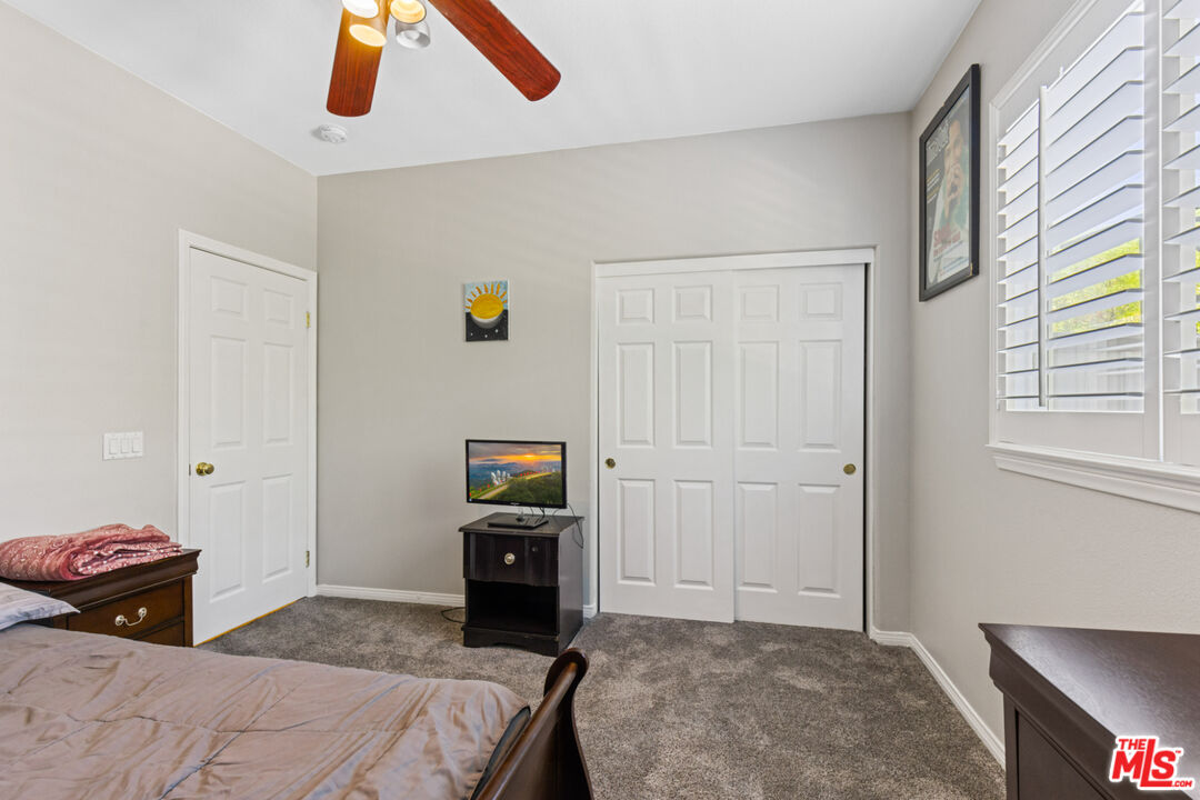 8256 Daisy Lane Riverside, CA 92508 - Photo 20 of 29 a bedroom with a bed and painting on the wall