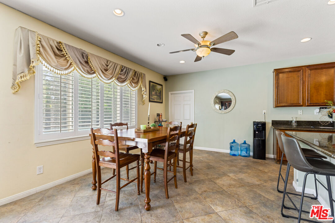 8256 Daisy Lane Riverside, CA 92508 - Photo 8 of 29 a view of a dining room and livingroom with furniture window and a ceiling fan