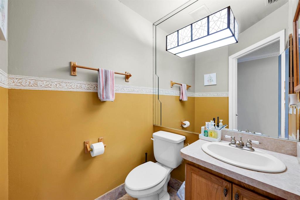 3963 Cocoplum Circle, Unit F Coconut Creek, FL 33063 - Photo 11 of 35 a bathroom with a sink a toilet and mirror