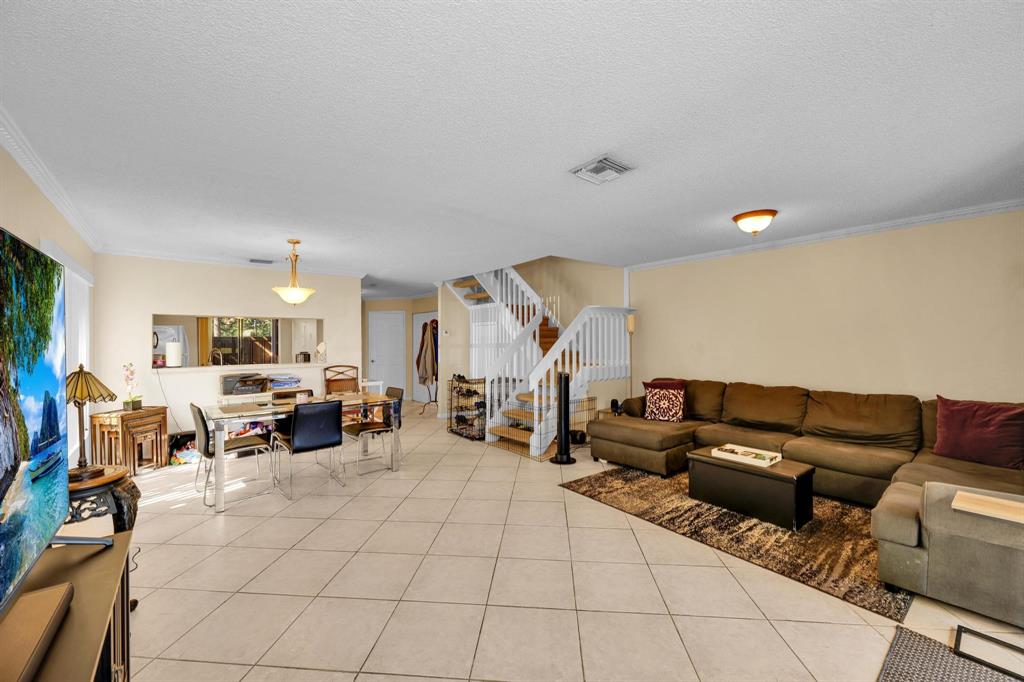 3963 Cocoplum Circle, Unit F Coconut Creek, FL 33063 - Photo 17 of 35 a living room with furniture and a couch