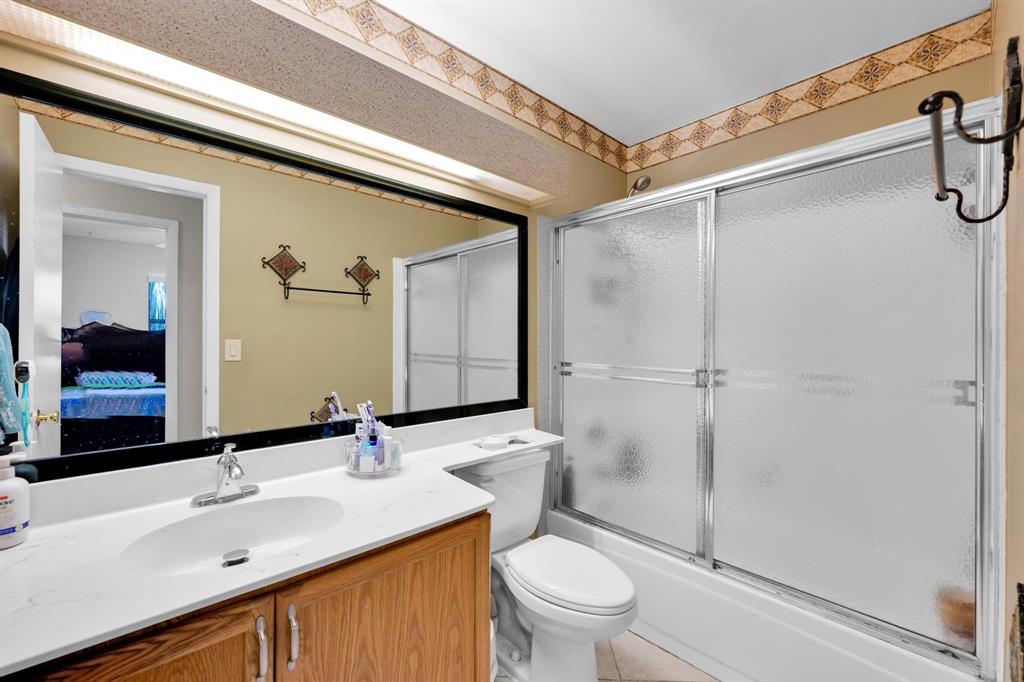 3963 Cocoplum Circle, Unit F Coconut Creek, FL 33063 - Photo 22 of 35 a bathroom with a sink toilet and shower