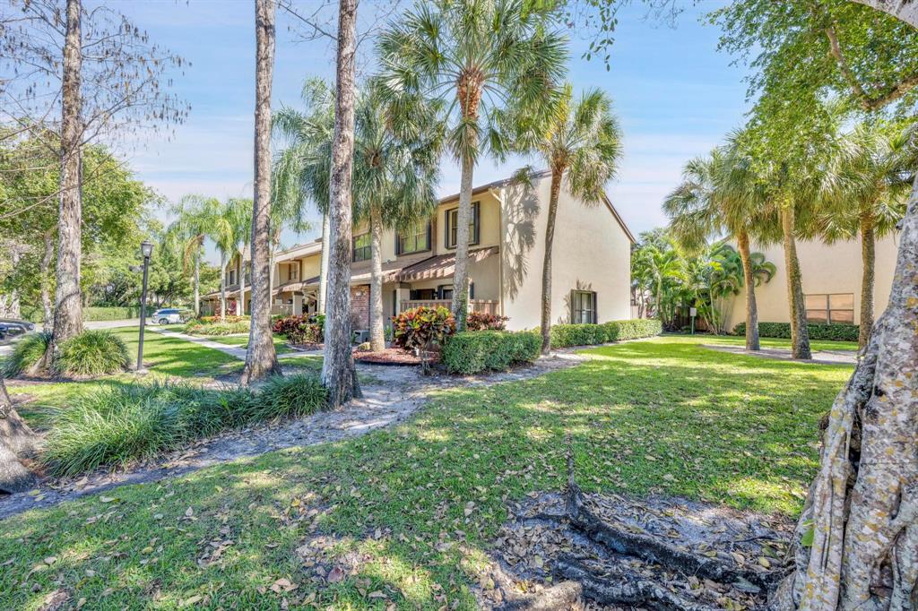 3963 Cocoplum Circle, Unit F Coconut Creek, FL 33063 - Photo 3 of 35 a view of a house with a yard