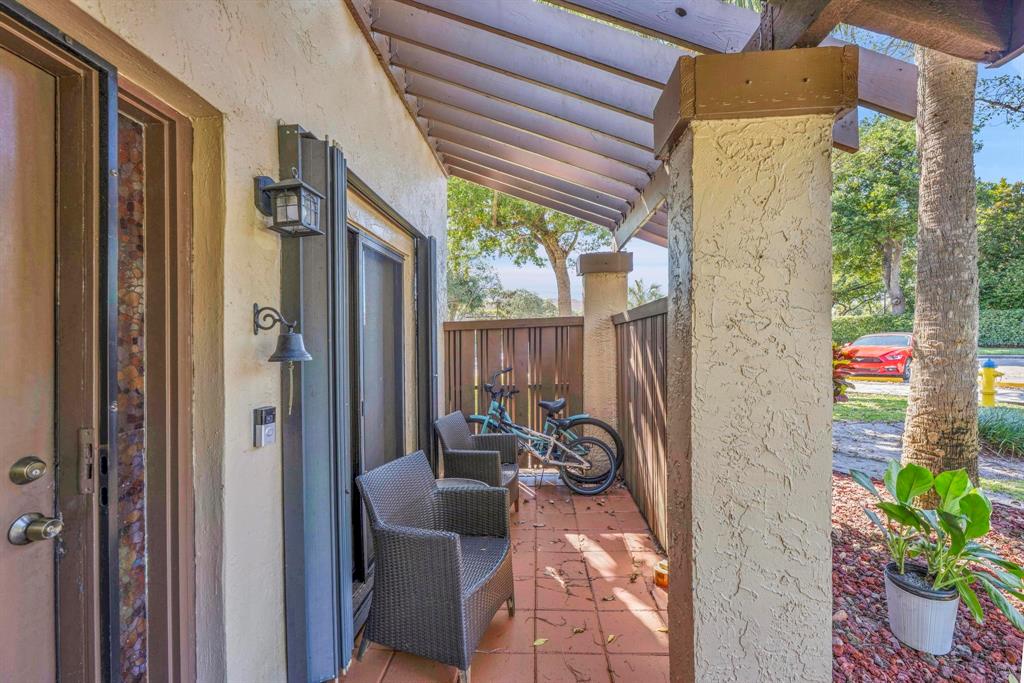 3963 Cocoplum Circle, Unit F Coconut Creek, FL 33063 - Photo 7 of 35 a backyard of a house with outdoor seating