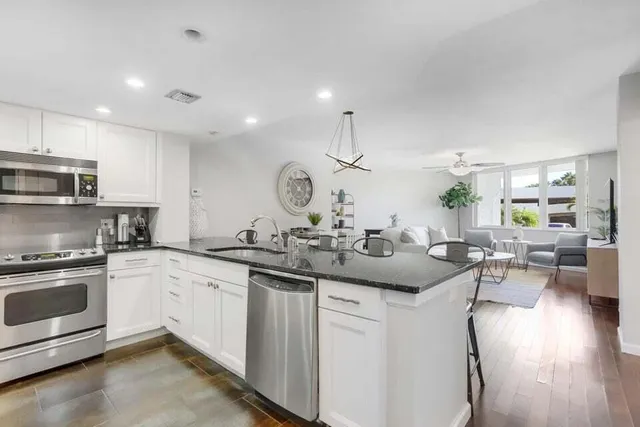 a kitchen with a sink stove and cabinets