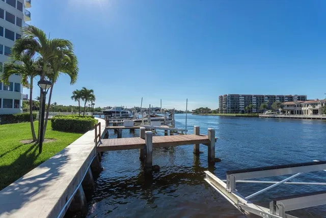 a view of a lake with couches chairs