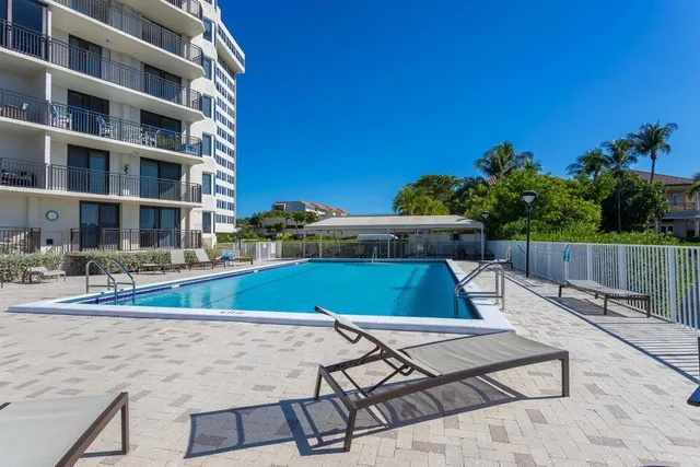 a view of a swimming pool with a lounge chairs