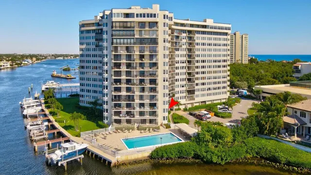 a dining room with furniture water view and large windows