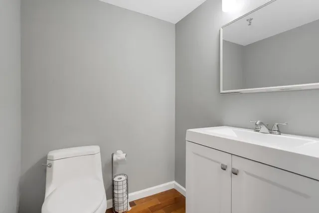 a bathroom with a toilet sink and mirror