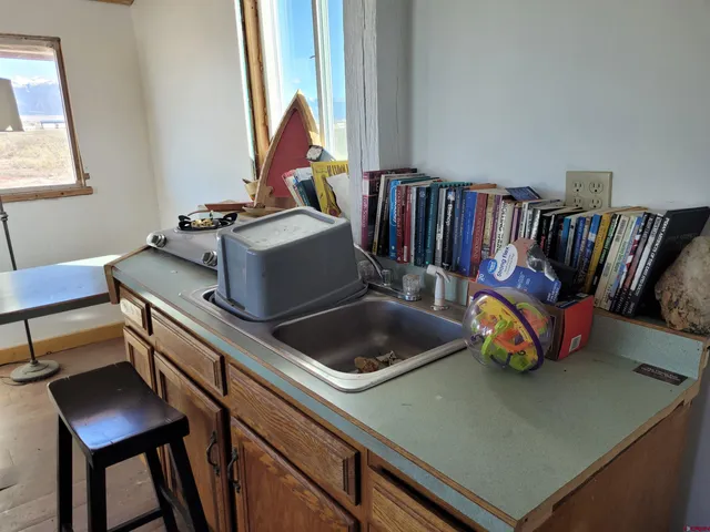 a view of a hallway with a chair and a fireplace