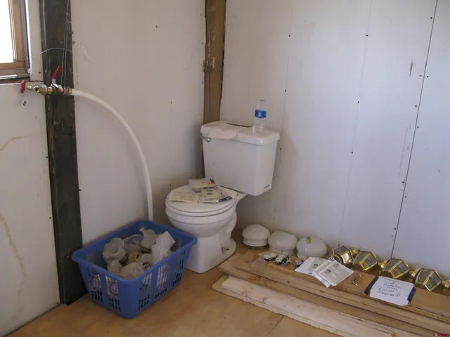 a bathroom with a sink toilet and a mirror