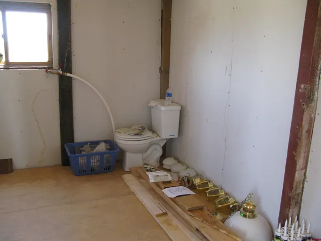 a bathroom with a sink toilet and a mirror