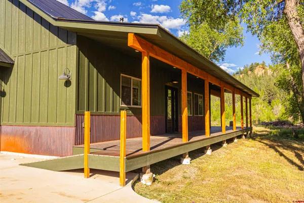 a view of a house with wooden walls and stairs