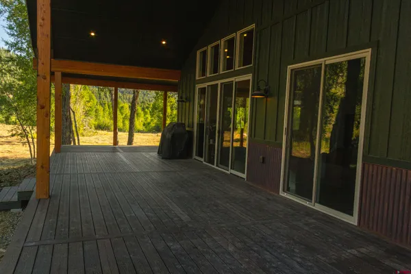 a view of porch with wooden floor and floor to ceiling window