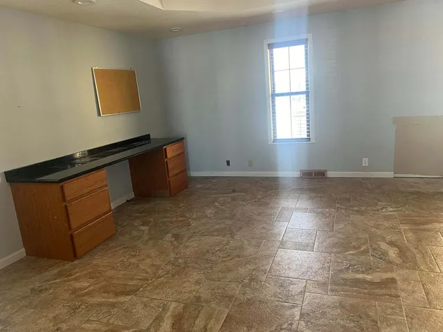 an empty room with closet and a bathroom