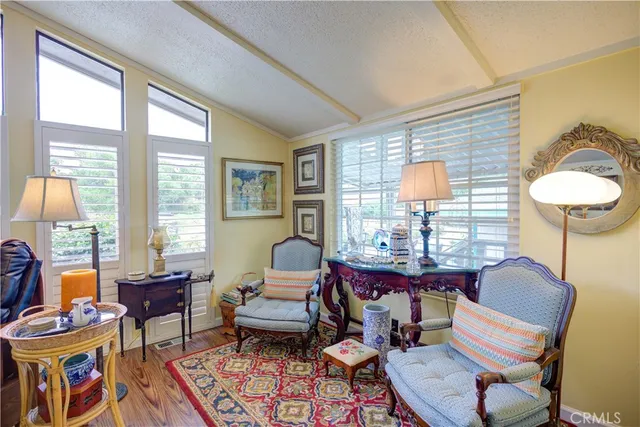 a view of a dining room and hall with furniture wooden floor and a chandelier