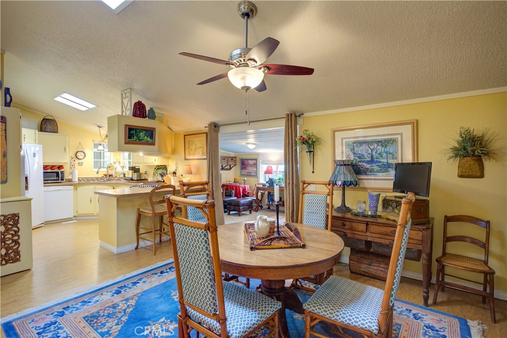 1675 Los Osos Valley Road, Unit 223 Los Osos, CA 93402 - Photo 25 of 68 a view of a dining room with furniture and wooden floor