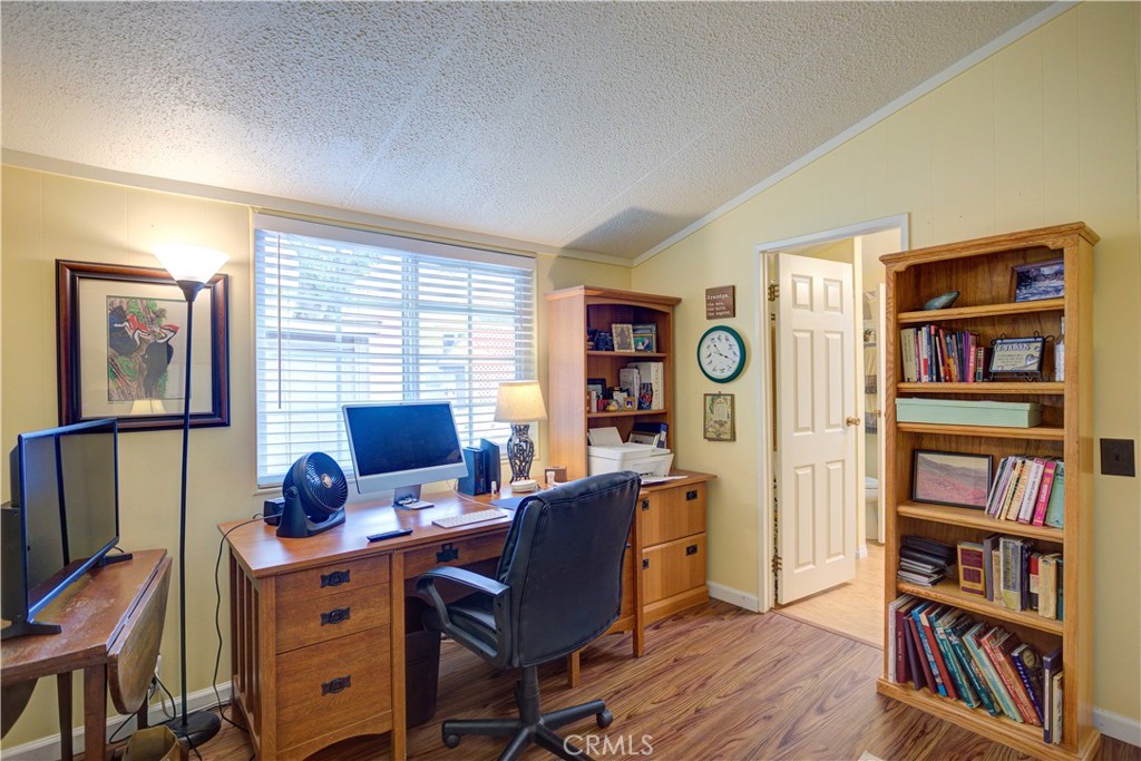 1675 Los Osos Valley Road, Unit 223 Los Osos, CA 93402 - Photo 35 of 68 a view of a workspace with bookshelf and a window