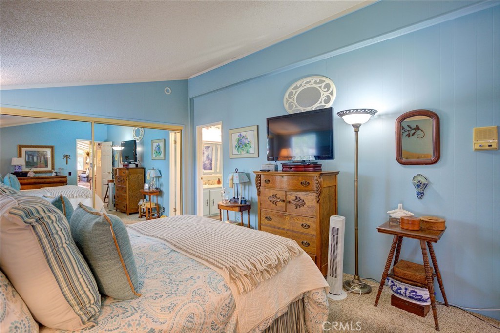 1675 Los Osos Valley Road, Unit 223 Los Osos, CA 93402 - Photo 41 of 68 a bedroom with a bed a mirror on dresser and a large mirror