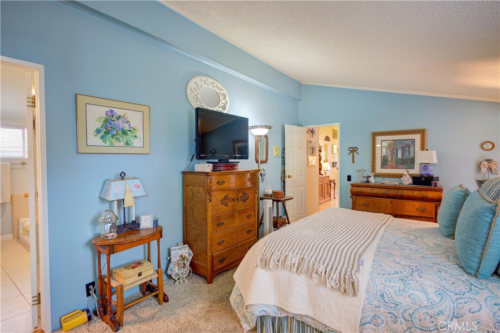 1675 Los Osos Valley Road, Unit 223 Los Osos, CA 93402 - Photo 42 of 68 a bedroom with furniture and a flat screen tv