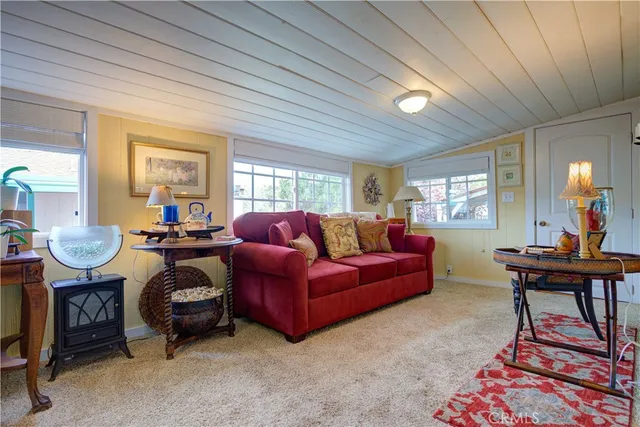 an aerial view of a house with swimming pool and large trees