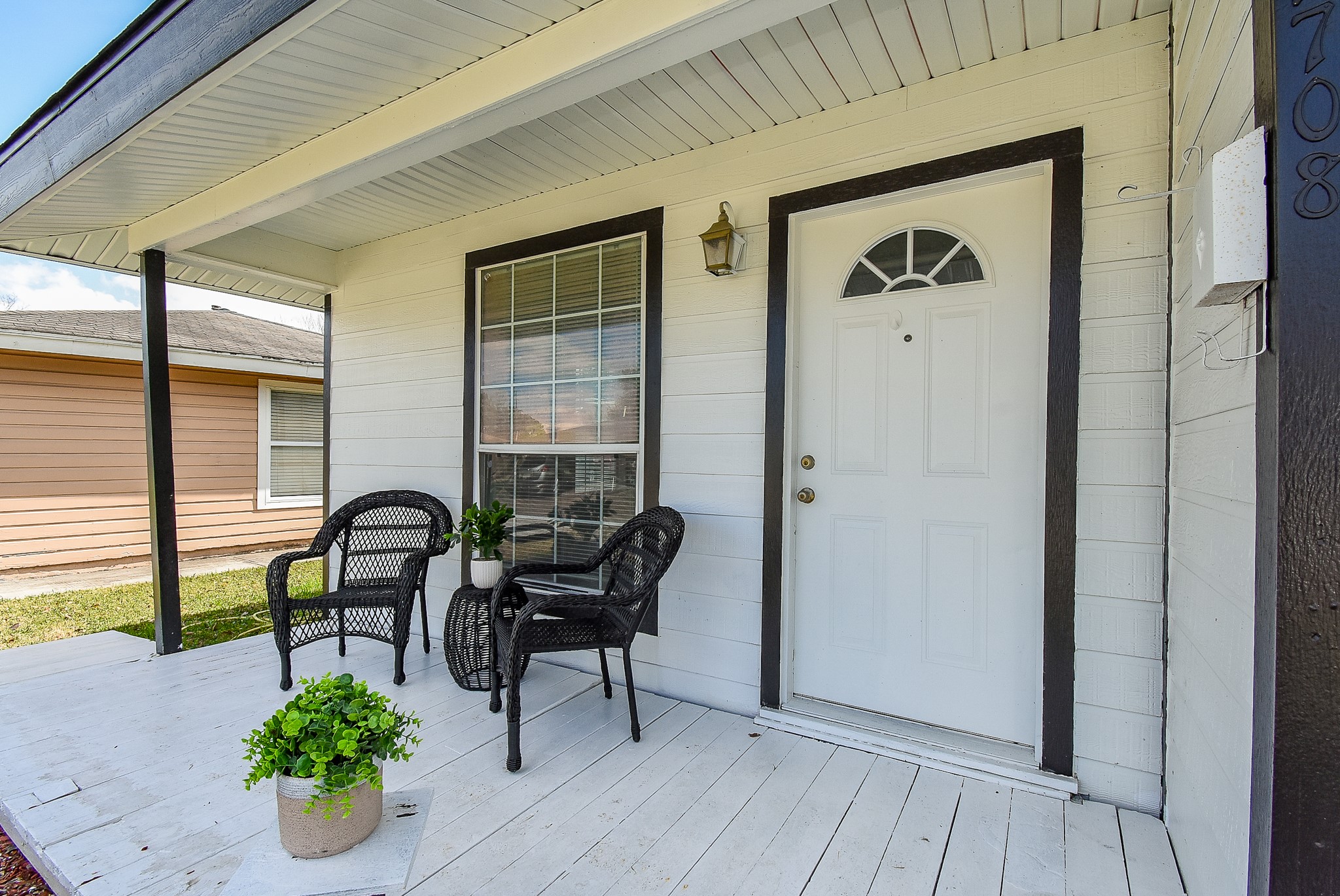 FRONT PORCH WAS REPAINTED BLACK & MULCH ADDED (See photos 7 & 8)