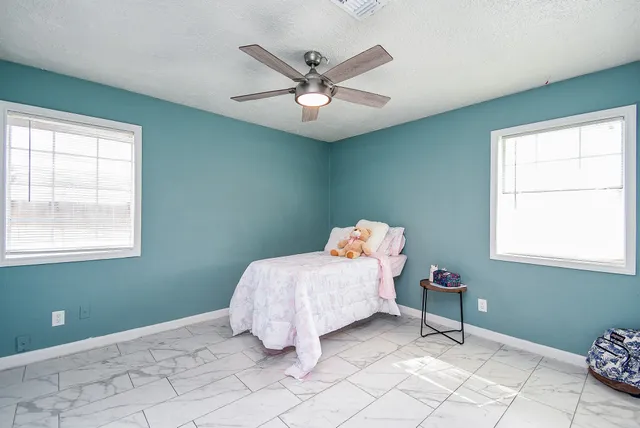 a bed room with a bed and a chandelier