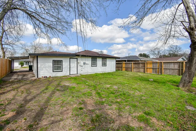 a view of a backyard with large trees