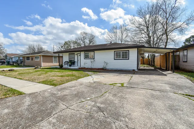 a view of a house with a swimming pool and a yard