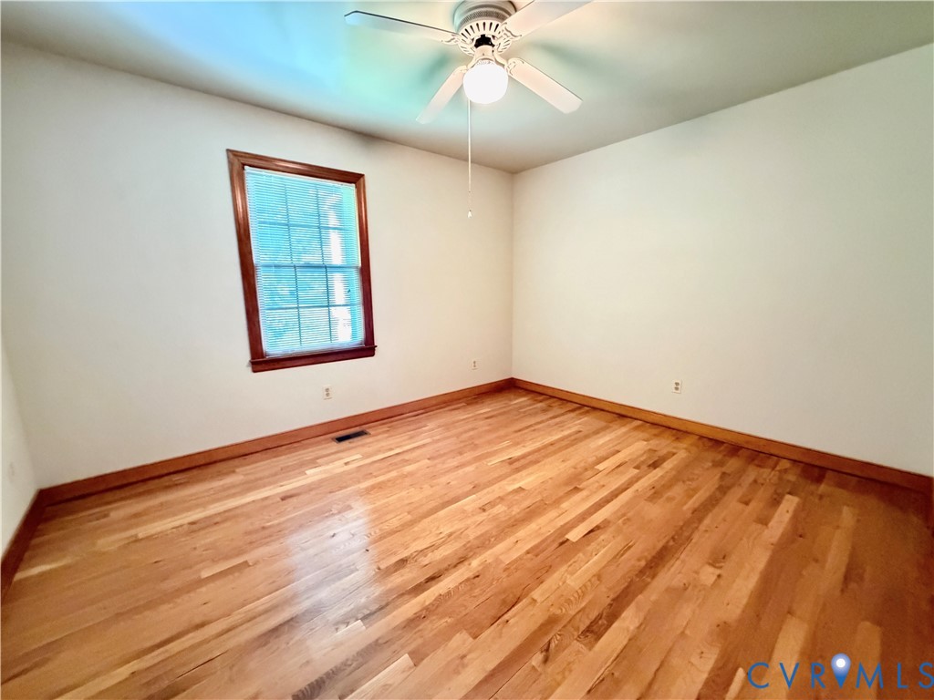 3933 Dunraven Road North Chesterfield, VA 23236 - Photo 26 of 30 an empty room with a window and ceiling fan