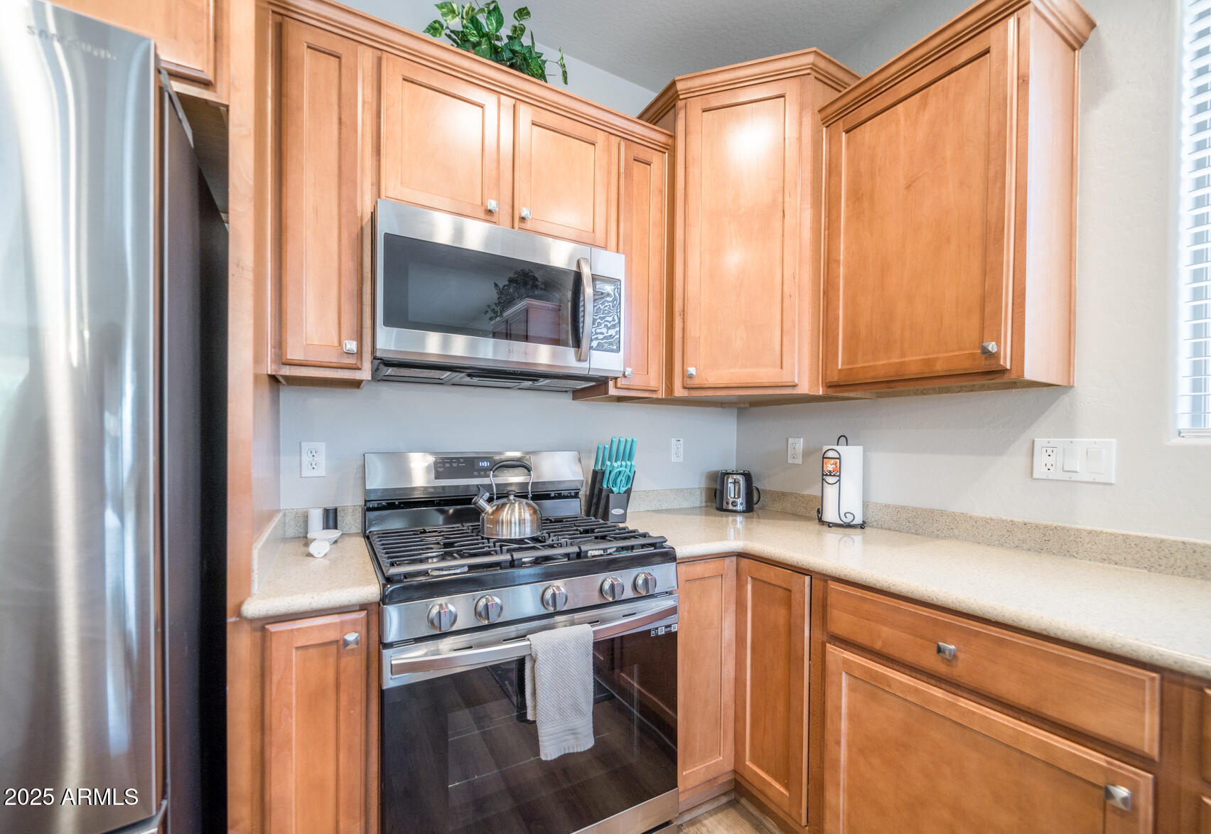 6375 West Heritage Way Florence, AZ 85132 - Photo 12 of 36 a kitchen with stainless steel appliances granite countertop a stove a sink and a microwave