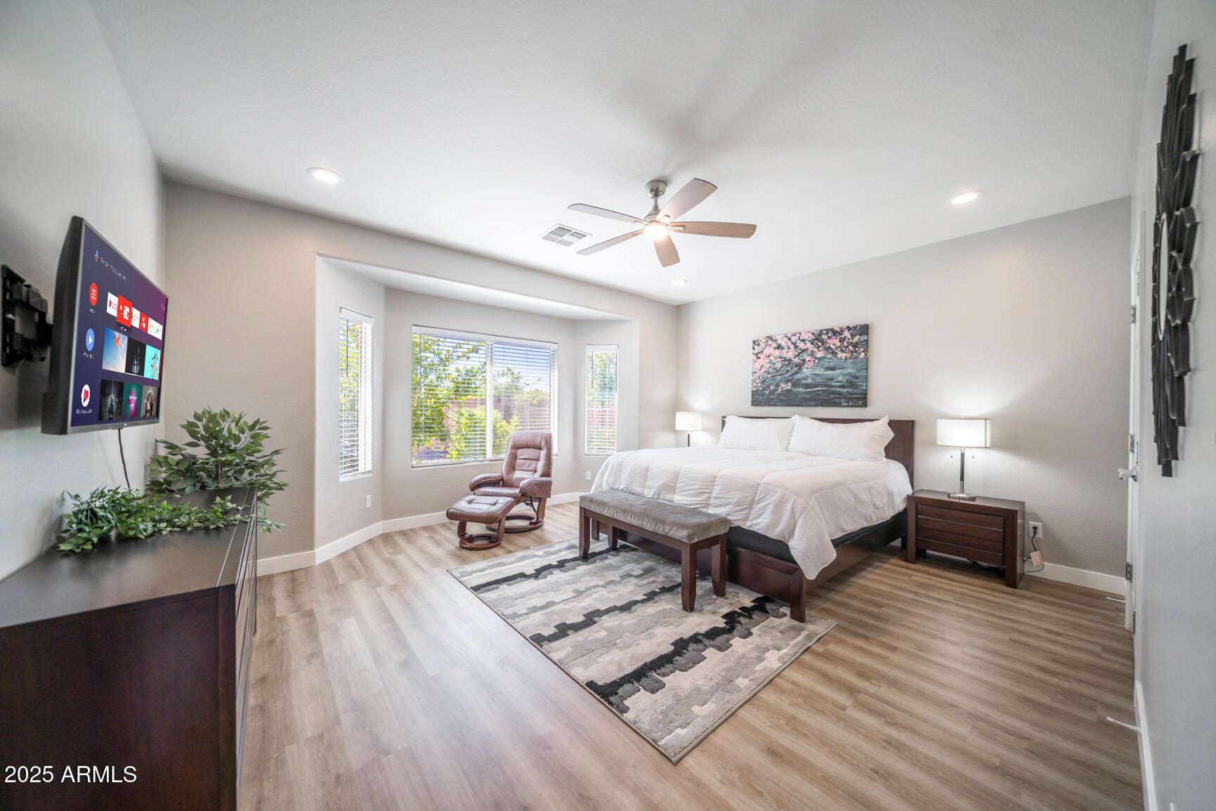 6375 West Heritage Way Florence, AZ 85132 - Photo 24 of 36 a bed sitting in a spacious bedroom next to a window and a flat screen tv