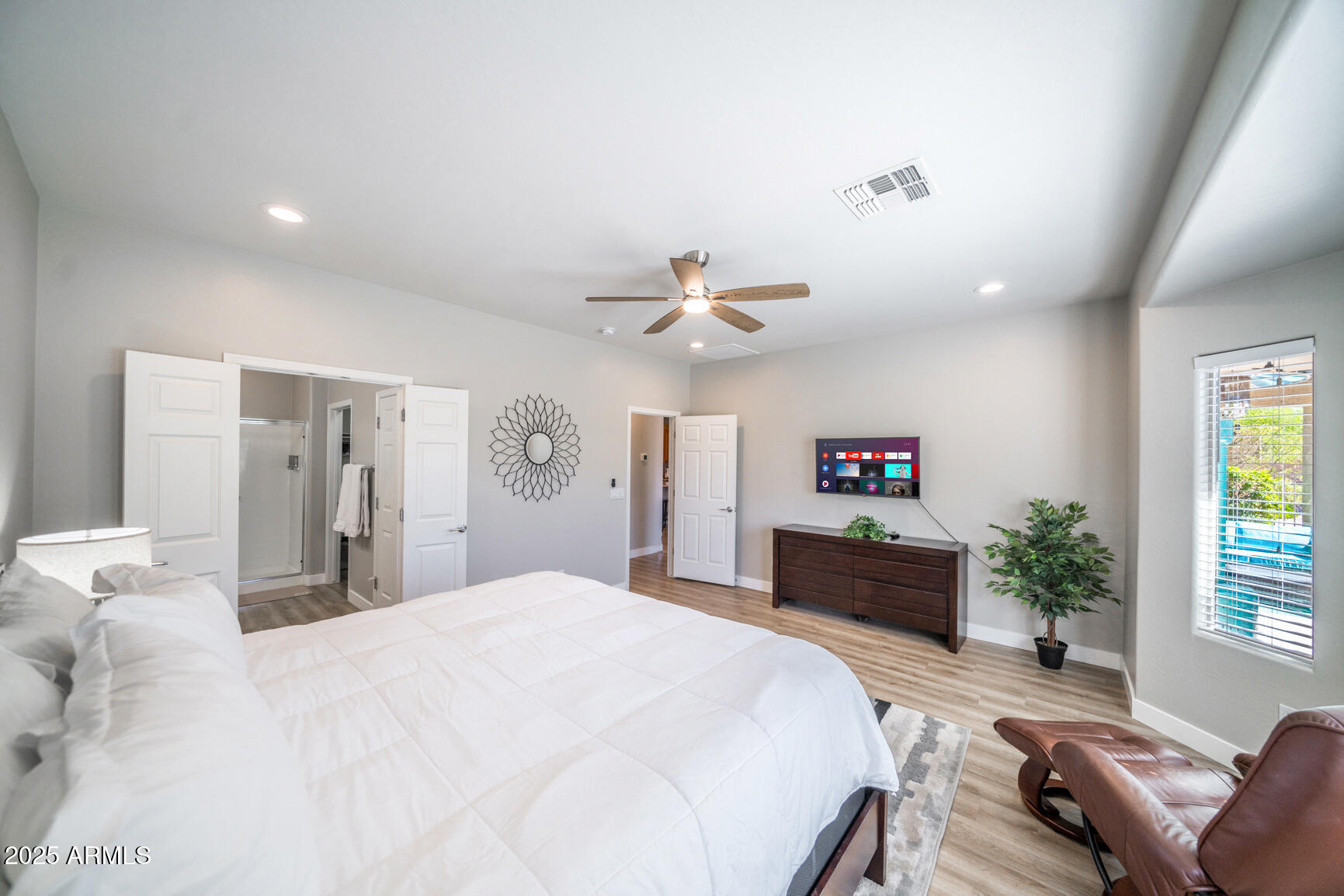 6375 West Heritage Way Florence, AZ 85132 - Photo 27 of 36 a spacious bedroom with a large bed and a chandelier