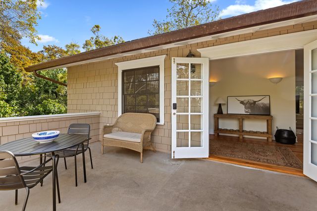 a view of a patio with table and chairs and potted plants