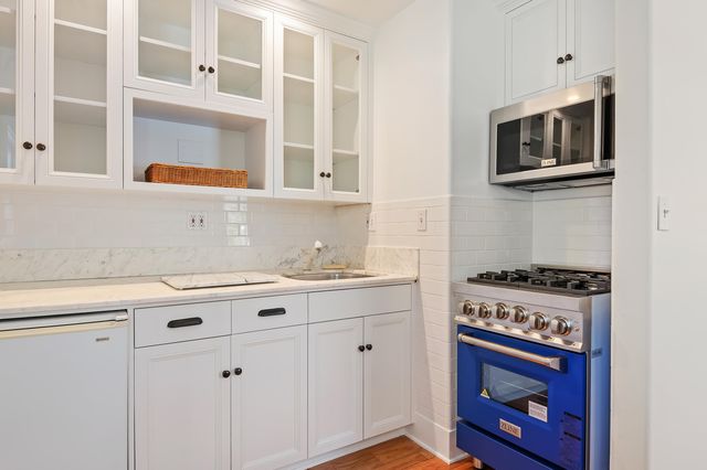 a kitchen with stainless steel appliances a stove and a microwave