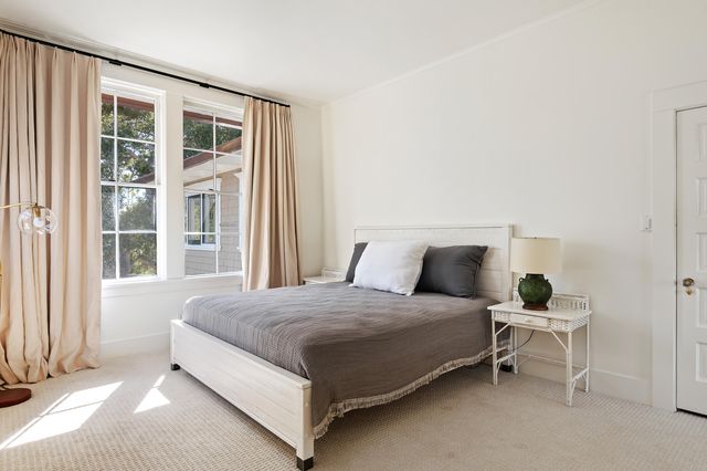 a bedroom with a bed flowerpot and window