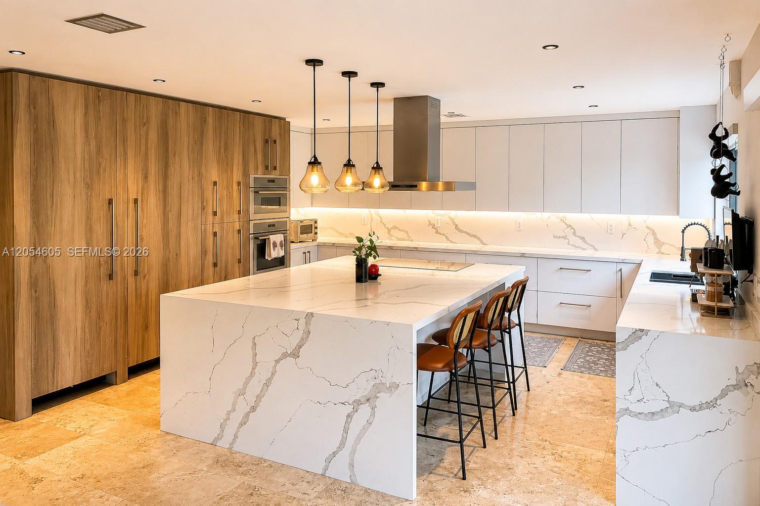 3538 Southwest 1st Avenue, Unit 1 Miami, FL 33145 - Photo 2 of 20 A true showpiece, this custom chef's kitchen was designed with no expense spared. Highlights include top-of-the-line Thermador appliances, separate full-size Miele refrigerator and freezer units, a spectacular oversized waterfall island that comfortably seats six, extensive custom cabinetry with abundant storage, quartz countertops and full-height backsplash, designer pendant lighting, and expansive prep space. Beautifully designed for both serious cooking & effortless entertaining, centerpiece of the home