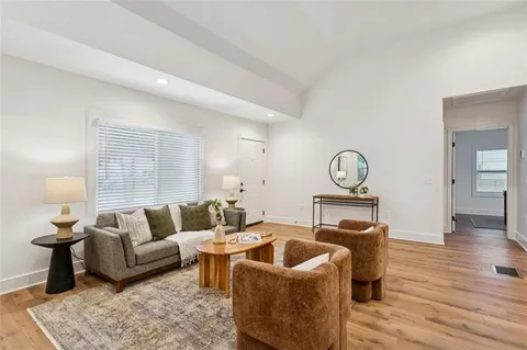 a living room with furniture a rug and a window