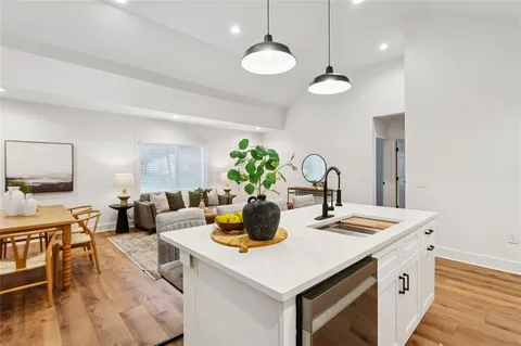 a kitchen with a sink a counter and chairs