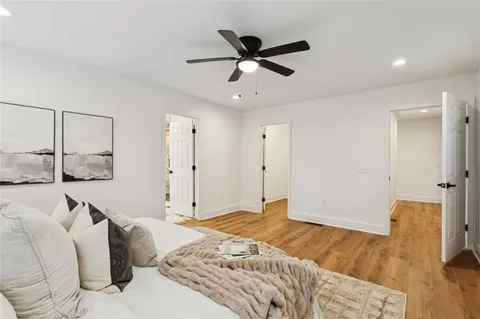 a bedroom with a bed and a ceiling fan