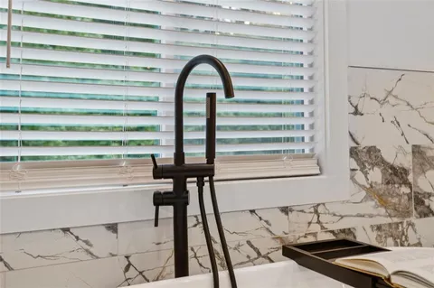 a close view of a sink and a kitchen floor