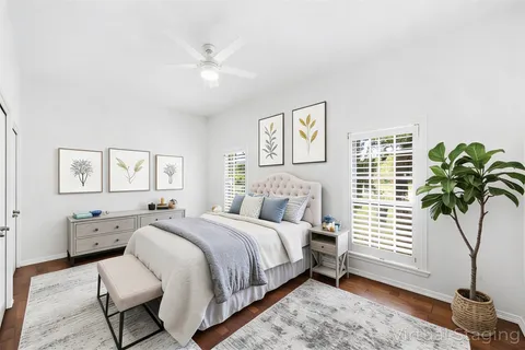 a bedroom with a bed and a potted plant