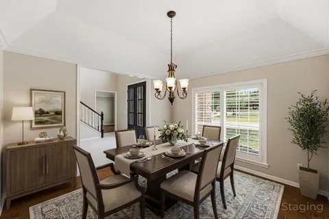 a dining room with furniture window and wooden floor