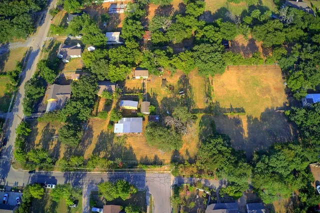 an aerial view of residential house with outdoor space and trees all around